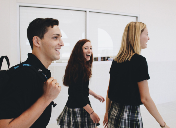 Three students walking together in class