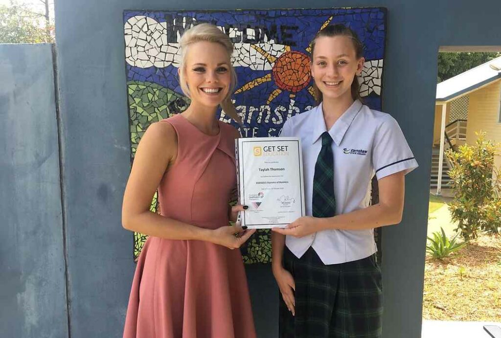 Kate Walsh presenting a certificate to a student